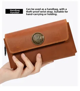 Detailed view of dark brown crazy horse leather wallet with antique relief emblem