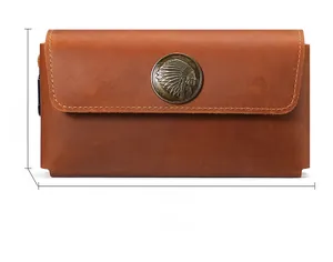 Front view of brown crazy horse leather pouch with vintage indian metal emblem detail