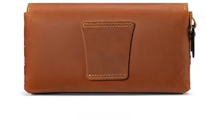 Macro detail of the back belt loop and metal hook on this brown leather waist bag