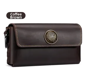 Macro detail of dark brown crazy horse leather pouch with vintage metal Indian badge