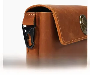 Close-up of crazy horse leather waist bag with a black matte metal carabiner hook