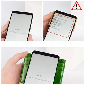 Detail of slim oil wax leather card holder showing NFC scanning function with a smartphone