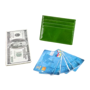 Macro shot of slim green oil wax leather card holder with three card slots and smooth texture