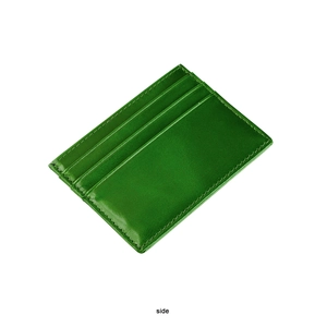 Detail view of green oil-wax leather card holder showing three slots and precise stitching