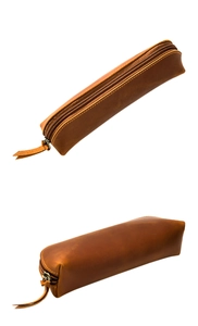 Macro shot of vintage brown crazy horse leather pencil case with brass zipper and fine stitching