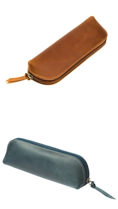 Detailed view of vintage crazy horse leather pencil cases in brown and dark cyan colors