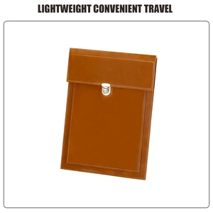 Detail of premium brown leather texture and silver metal snap button on laptop sleeve