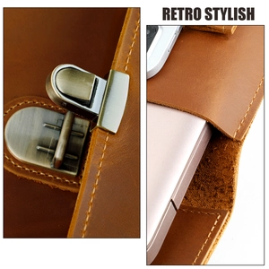 Detail of brown leather laptop sleeve with retro metal clasp and precise stitching