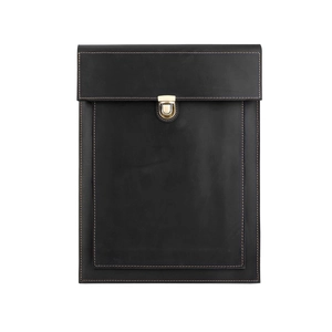 Detail of matte black leather laptop case with gold metal clasp and contrast stitching