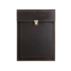 Detailed view of dark brown leather laptop sleeve with vintage metal clasp and stitching