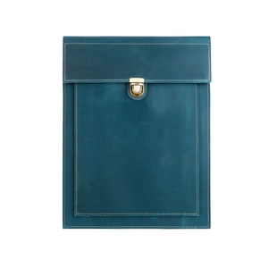 Detail view of leather laptop sleeve with peacock blue finish and gold buckle closure