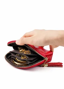Detail of red pebbled leather jewelry pouch with tassel zipper and internal compartments