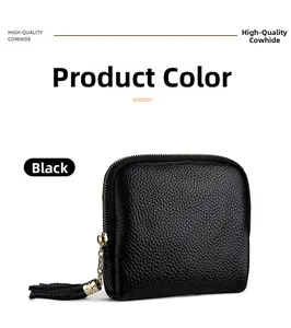 Detail of black pebbled cowhide leather jewelry pouch with gold zipper and leather tassel