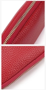 Macro detail of high-quality red lychee leather texture and smooth golden metal zipper