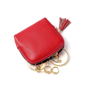 Red lychee grain leather jewelry organizer with metal zipper and gold accessories