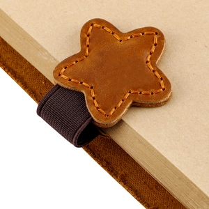 Detail of star-shaped crazy horse leather bookmark with orange stitching and elastic band