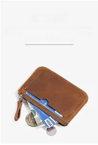 Detail view of brown leather coin purse showing zipper pocket and external card slot