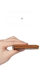 Slim vintage leather coin purse showing ultra-thin profile and precise stitching