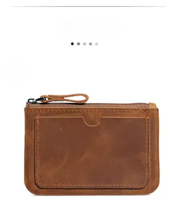 Detail shot of vintage brown crazy horse leather card holder with secure metal zipper