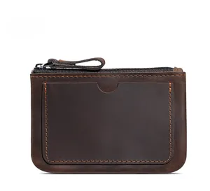 Detail of coffee vintage leather coin purse with top zipper and contrast stitching