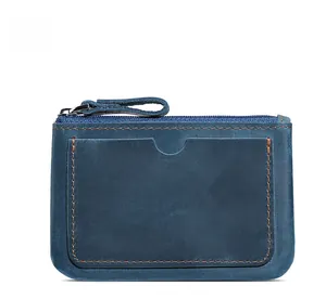 Detail of blue crazy horse leather card holder with contrast orange stitching and zipper