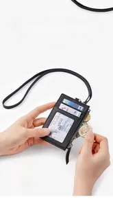 Detail of slim black leather ID holder with lanyard, zipper pocket and card slots