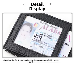 Close-up of black litchi leather card holder with clear ID window and metal zipper detail
