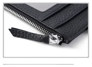 Macro shot of silver metal zipper and black litchi grain leather card holder texture