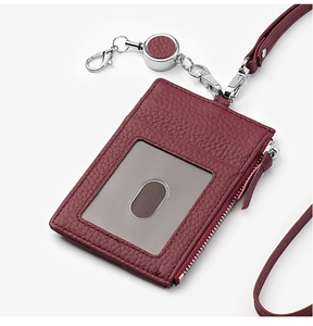 Detail of burgundy lychee leather ID card holder with silver zipper and retractable lanyard