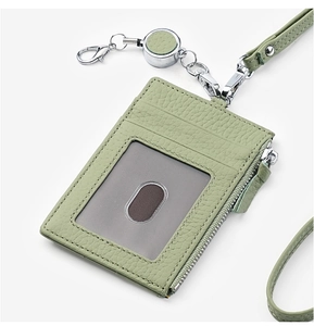 Detail view of mint green lychee textured leather ID badge holder with zipper pocket