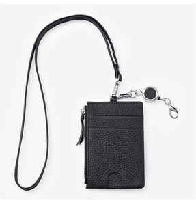 Close-up of black pebble leather badge holder with silver zipper and retractable lanyard