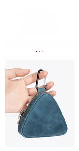 Macro shot of triangular crazy horse leather coin pouch with sturdy metal carabiner clip