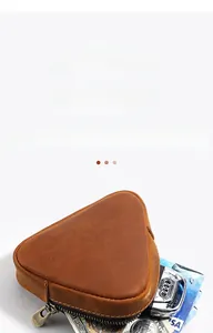 Macro shot of a triangular crazy horse leather wallet with coins and car keys inside