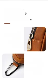 Detailed macro view of the premium metal zipper and durable spring hook on leather pouch