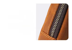 Detail of crazy horse leather coin purse showing precise stitching and vintage metal zipper