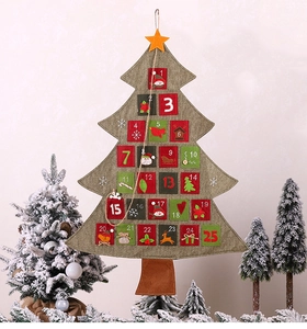 Close-up of burlap Christmas tree advent calendar with 25 numbered festive pockets