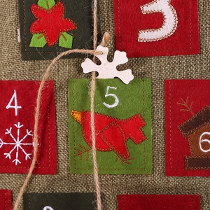 Christmas burlap advent calendar featuring red and green felt pockets with festive embroidery