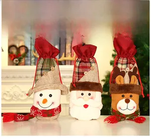 Detailed view of three festive Christmas wine bottle covers with reindeer and Santa designs