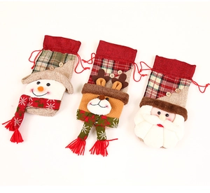Detailed view of Christmas fabric gift bags with reindeer, snowman and Santa claus designs