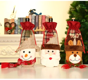 Three festive Christmas wine bottle covers featuring Santa, snowman, and reindeer designs