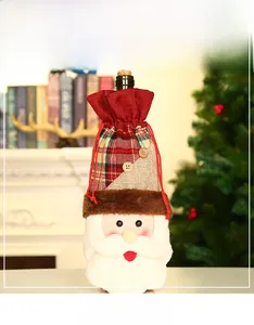 Detail of Christmas Santa wine bottle cover with white plush and red knit fabric