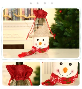 Detail of creative Christmas snowman wine bottle cover with red scarf and plush fabric