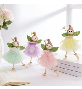 Detail of four handmade fabric fairy dolls in macaron colors with tulle skirts and wings