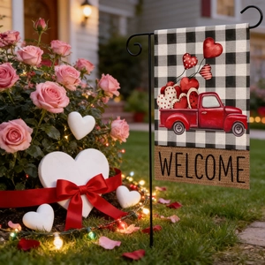 Valentine's Day garden flag with red truck and hearts in a warm outdoor setting