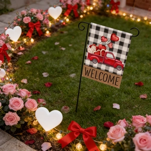 Close-up of Valentine’s Day garden flag with red truck and Buffalo plaid on outdoor lawn