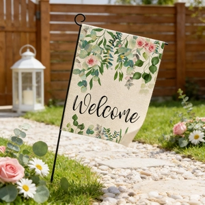 Detailed view of linen garden welcome flag with floral print in a sunny outdoor wedding scene