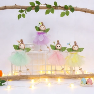 Detail of fairy hanging ornaments with colorful tulle dresses and warm LED fairy lights