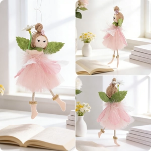 Detail of fairy ornament with pink mesh dress, green wings and white daisy flower decoration