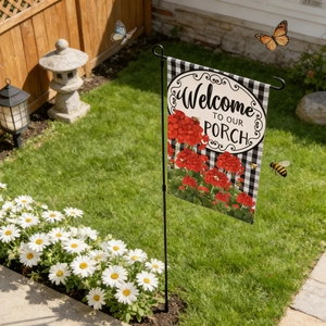 Garden flag detail showing Welcome To Our Porch text on black and white plaid fabric