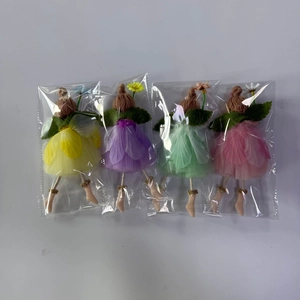 Close-up of four handmade fairy dolls with colorful mesh skirts in clear packaging